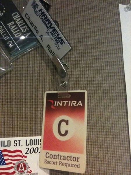 Charles A. Rallo name tags and Intira contractor badge on mesh: Rallo Co. nameplate, Harvey's Casino Hotel badge, Intira Contractor Escort Required ID, and partial Build St. Louis sticker