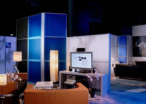 Lounge seating and demo screen inside the Phantom booth