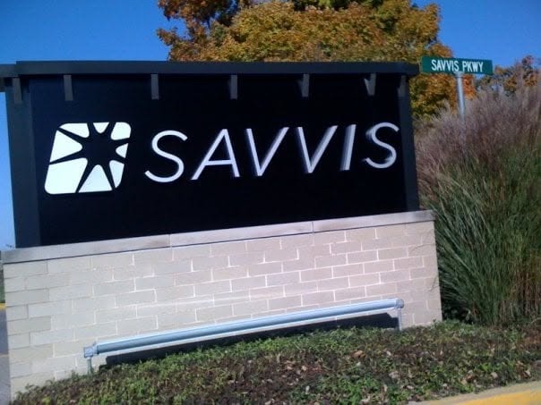 Outdoor SAVVIS monument sign with SAVVIS PKWY street sign and autumn trees in the background